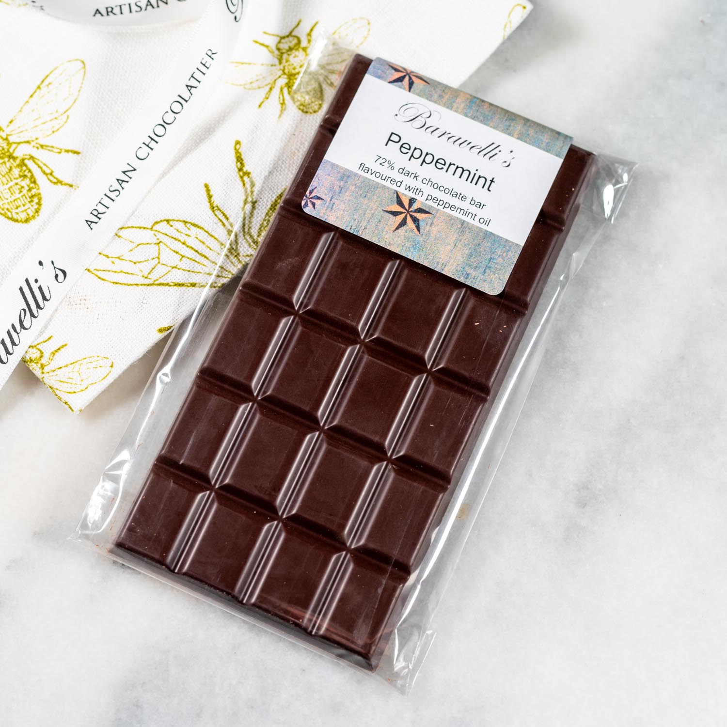 Baravelli's Peppermint 72 percent dark chocolate bar on the bee print tissue